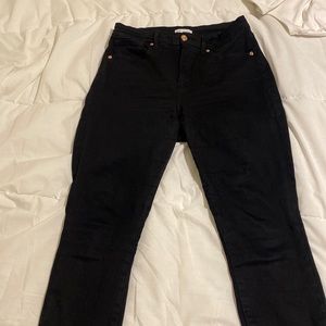 Good American black skinny jeans with tiny slit